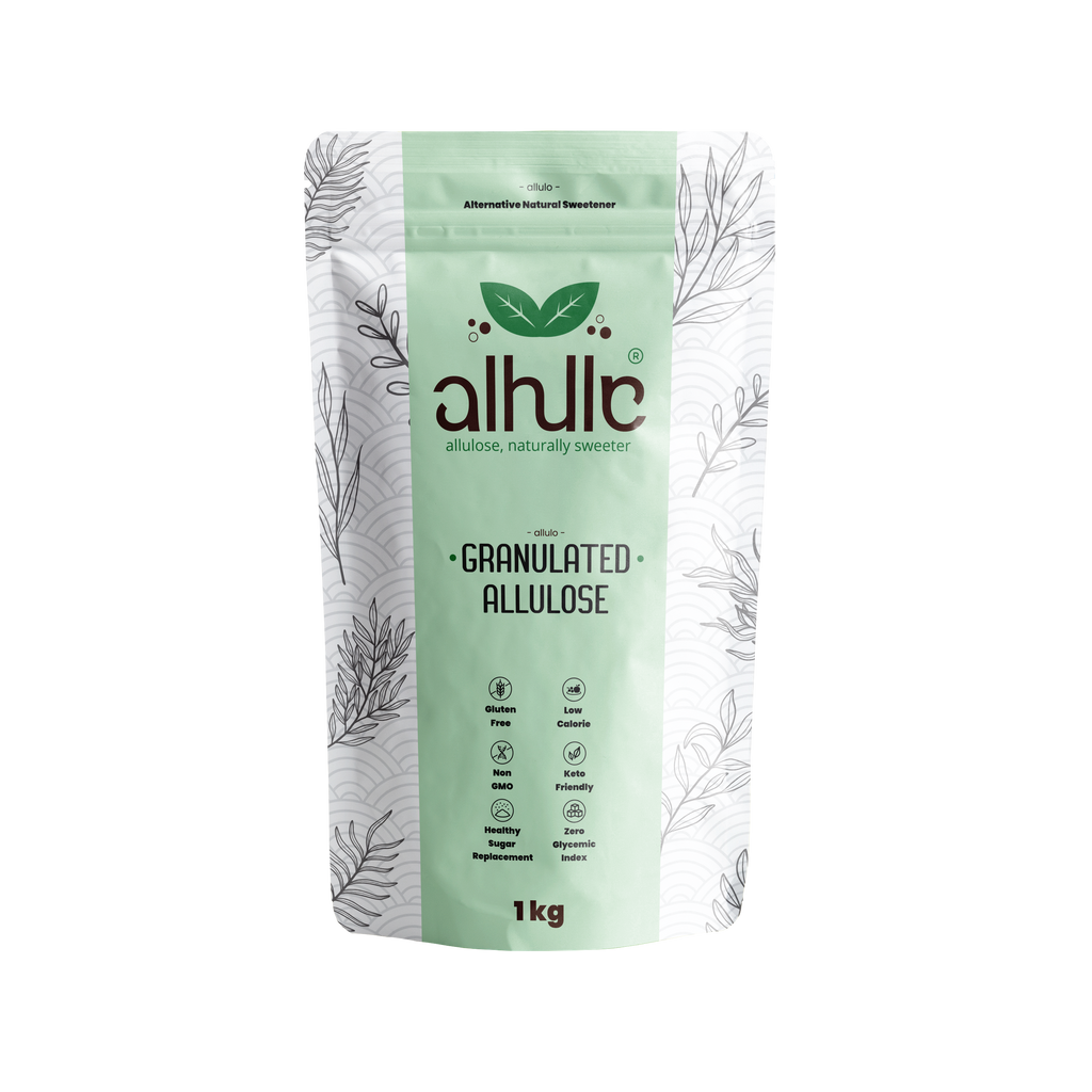 A 1kg stand-up pouch of alhllc Granulated Allulose, featuring a light mint green and white design with botanical line drawings and the brand logo.