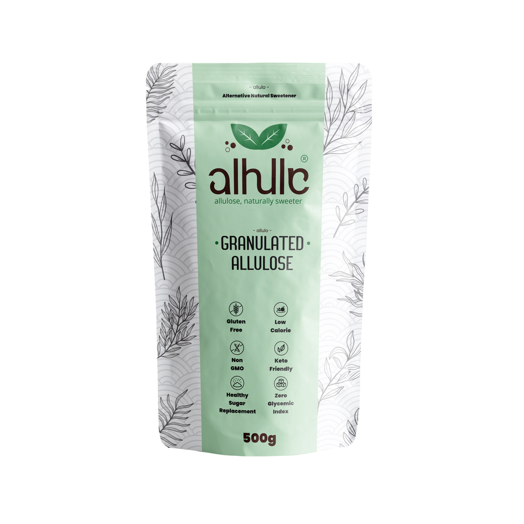 A 500g stand-up pouch of allulo Granulated Allulose sweetener, featuring a light mint green front with black botanical line art and dark brown brand lettering, set against a plain white background.
